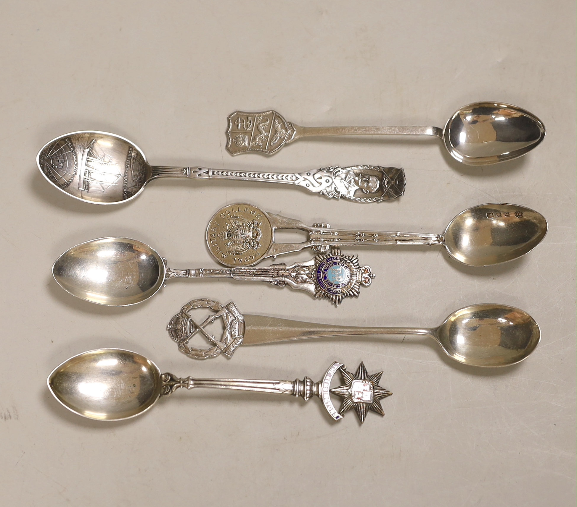 A Roald Amundsen commemorative .830 silver spoon, circa 1911, and five other commemorative spoons, of which four are silver including; Royal Military College, Small Arms School, Royal Army Service Corps, The Kensingtons